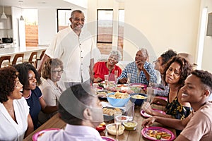 Three generation African American  family sitting at dinner table celebrating together,close up