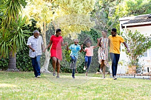 Three generation African American family spending time together in their garden.