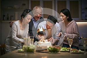 Three generation asian family celebrating little boy`s birthday at home