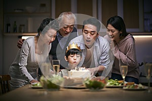 Three generation asian family celebrating little boy`s birthday at home