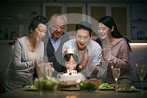 Three generation asian family celebrating little girl`s birthday at home