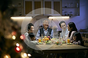 Three generation asian family having christmas dinner together at home