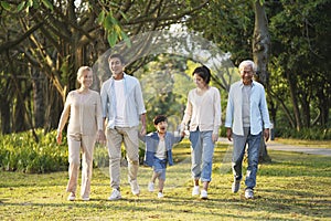 Three generation asian family walking in park