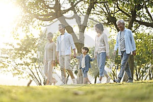 Three generation asian family walking in park