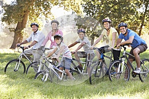 Three Generation Family On Cycle Ride In Countryside