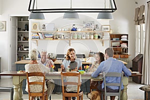 Three generation family eating in the kitchen at home