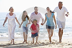 Three Generation Family Having Fun On Beach