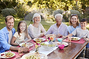 Three generation family having lunch in the garden