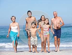 Three Generation Family On Holiday On Beach