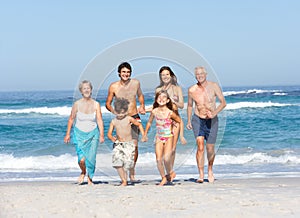 Three Generation Family On Holiday On Beach