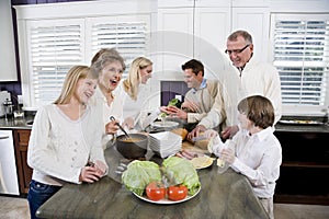 Three generation family in kitchen cooking lunch