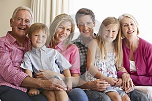 Three Generation Family Relaxing On Sofa At Home