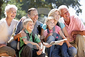 Three generation family resting on a country walk