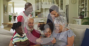 Three generation family using digital tablet at home