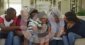 Three generation family using digital tablet at home