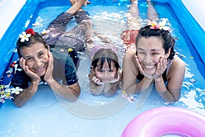 Three generation people swimming in Inflatable Pool at the summer time