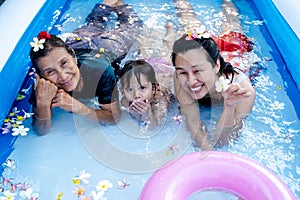 Three generation people swimming in Inflatable Pool at the summer time