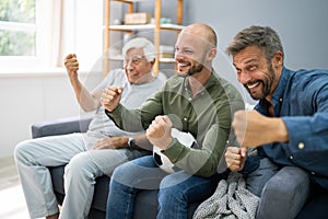 Three Generation Sport Fans Watching Football