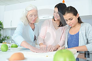 Three generation women making apple pie