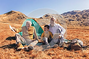 Three generations of family camping together in the autumn