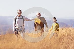 Three generations of family hiking together in the autumn