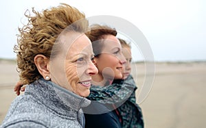 Three generations female looking at sea