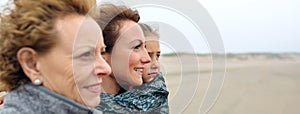 Three generations female looking at sea