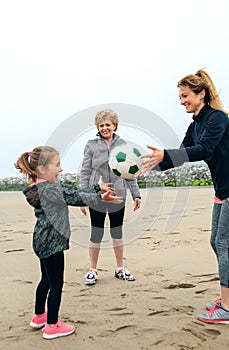 Three generations female playing on the beach