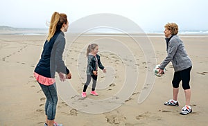 Three generations female playing on the beach