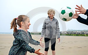 Three generations female playing on the beach