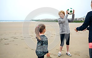 Three generations female playing on the beach