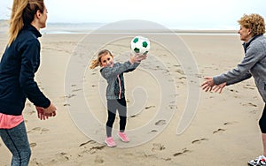 Three generations female playing on the beach