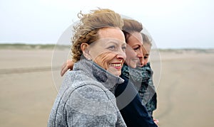 Three generations female walking on the beach