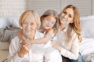 Three generations of females sitting behind each other