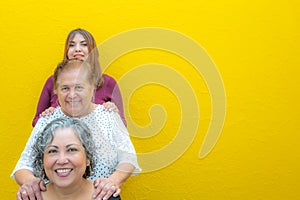 Three generations of latin Mexican women smiling in line, daughter, grandmother and granddaughter