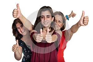 Three generations of latin women smiling and doing the thumbs up sign - On a white background