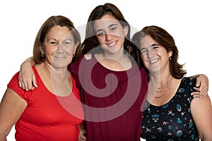 Three generations of latin women smiling and hugging - On a white background