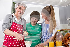 Three generations living together - happy family cooking together.