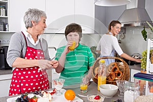 Three generations living together - happy family cooking together.