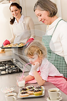Three generations of women baking in kitchen