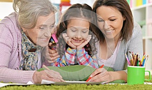 Three generations of women from one family lying on floor and dr