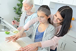 Three generations women preparing delicious dessert