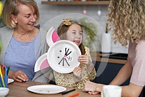 Three generations of women preparing Easter decorations