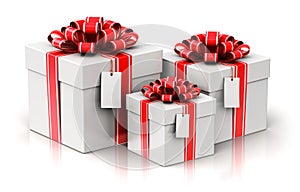 Three gift or present boxes with ribbon bows and label tags