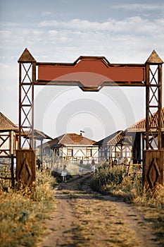 Three girl coming out of gate of the village