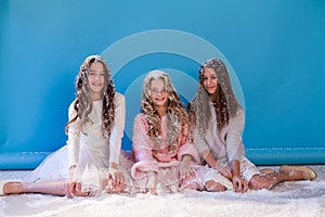 Three girl girlfriends play with snow in winter