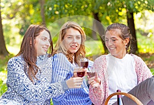 Three girlfriends drinking wine