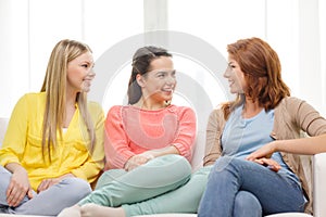 Three girlfriends having a talk at home