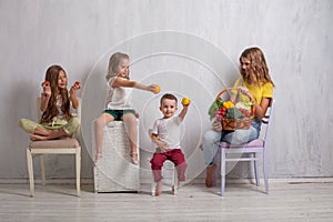 Three girls and a boy ripe vegetables and fruits