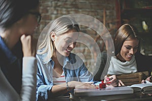 Three girls in cafe having fun.